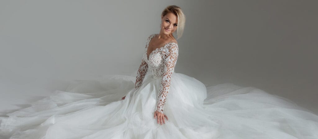 beautiful bride in luxurious wedding dress, sitting in circle long skirts. White background, top view